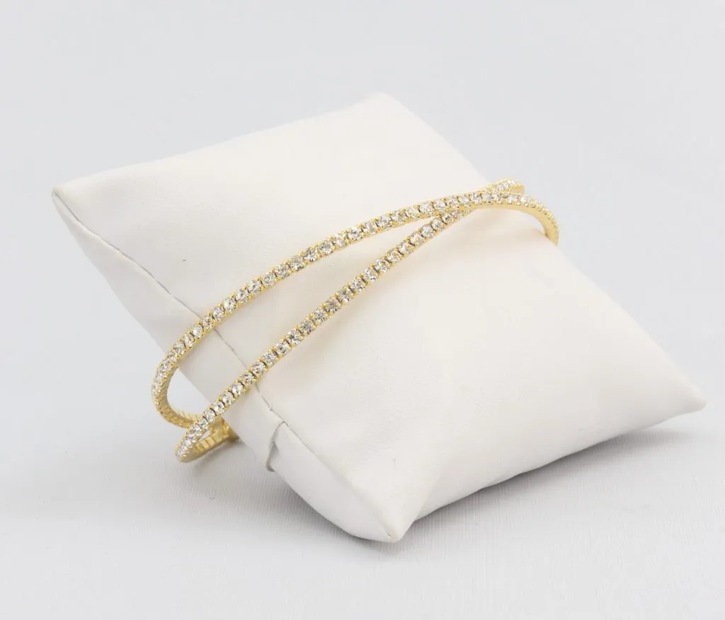 Criss-cross bracelet with inlaid simulated diamonds