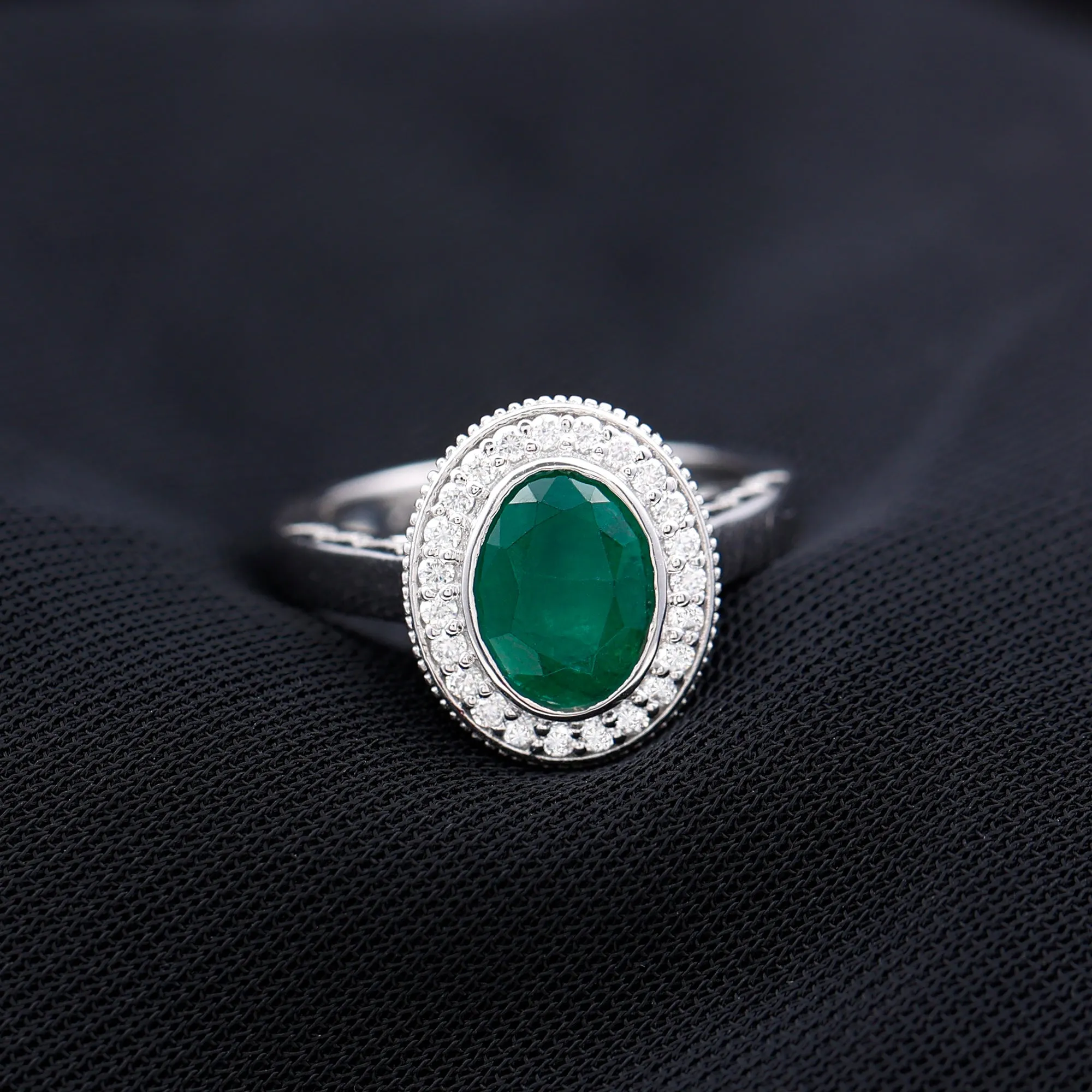 Oval Lab Grown Emerald and Diamond Halo Engagement Ring
