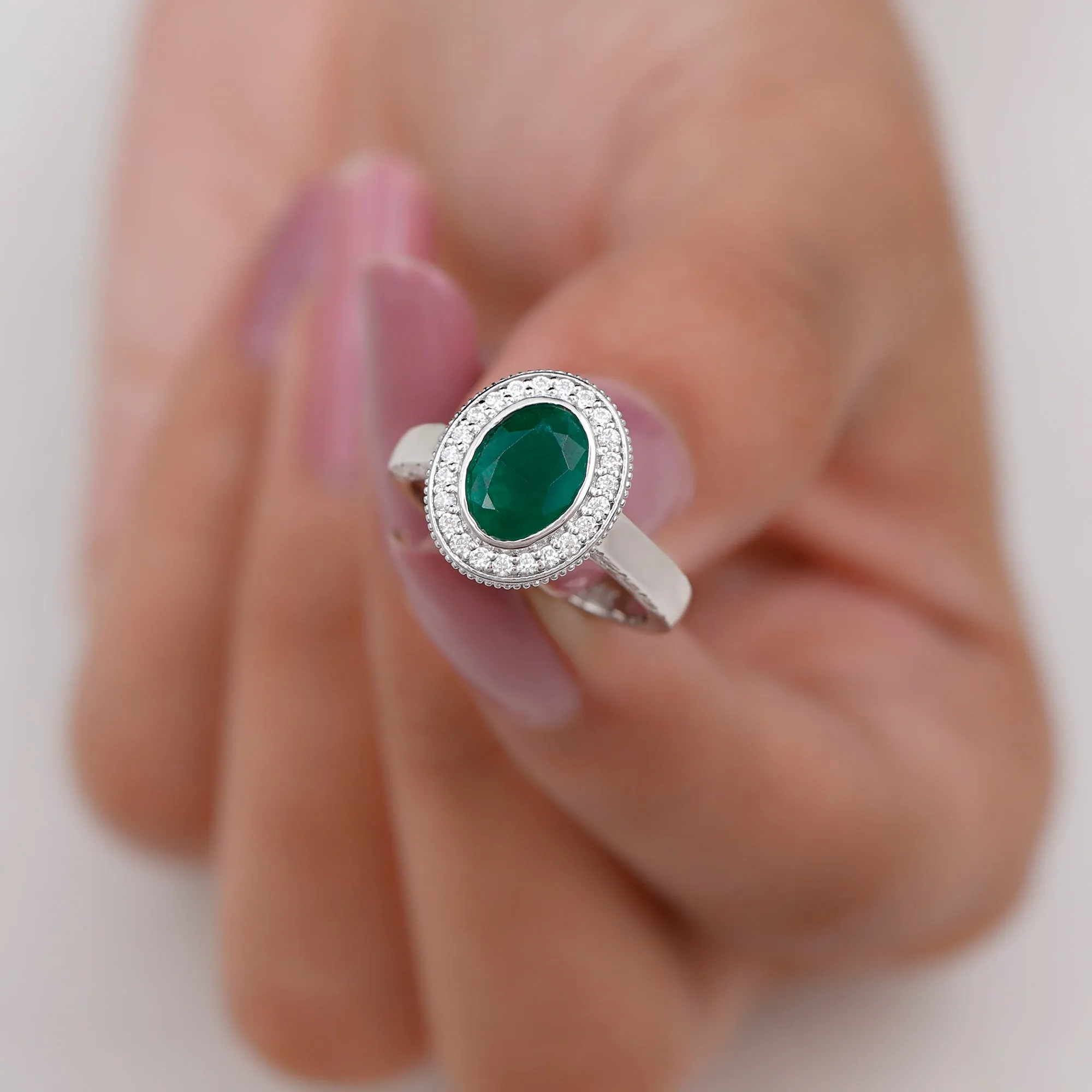 Oval Lab Grown Emerald and Diamond Halo Engagement Ring