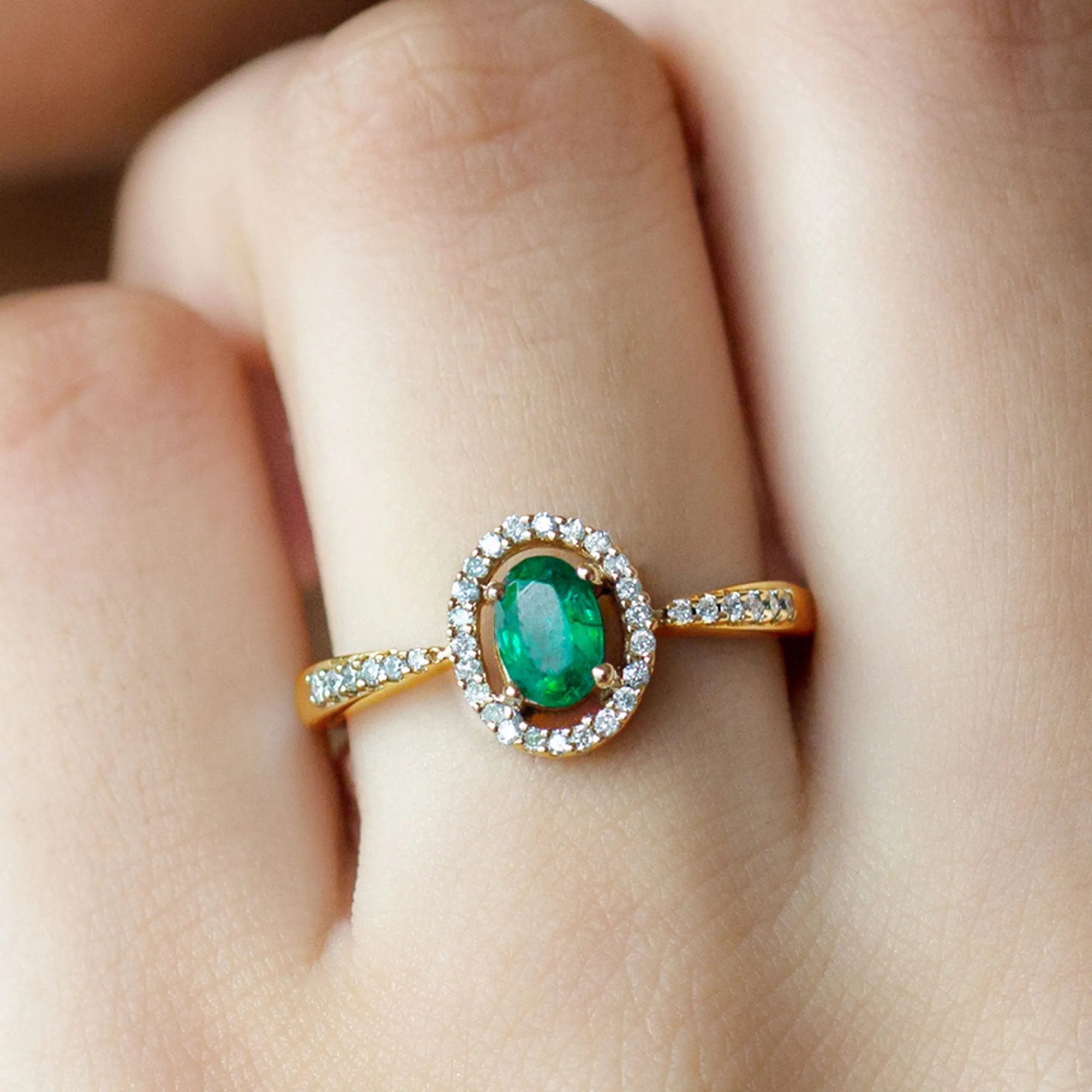 Oval shape Emerald and Diamond Halo Engagement Ring