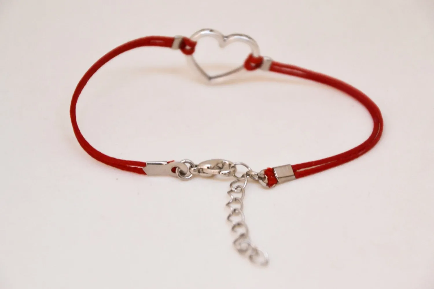Red bracelet with silver heart charm, adjustable bracelet